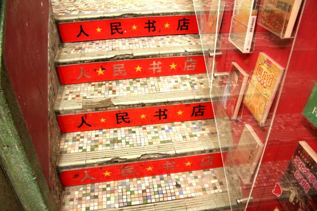 階段も赤。これだと踏み外すこともない？？階段右手の壁には売れ筋書籍がディスプレイされています。