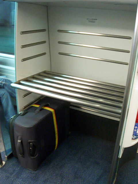 乗り込んだらまずスーツケースなどの大きな荷物は、専用の棚に収納します。各車両についていますので、目の届くところに置いてくださいね。