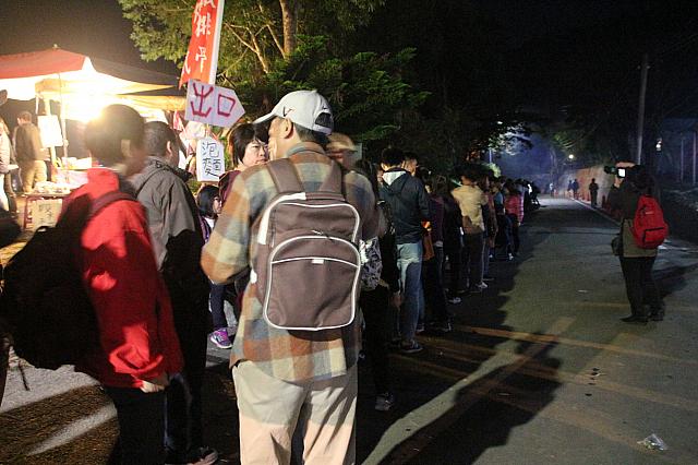 夜中に帰るため、バスを待つ人々